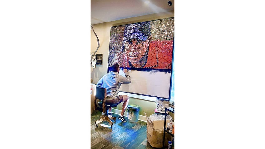 tiger woods fan creates mural of the player using 25000 golf tees see the artists stunning design