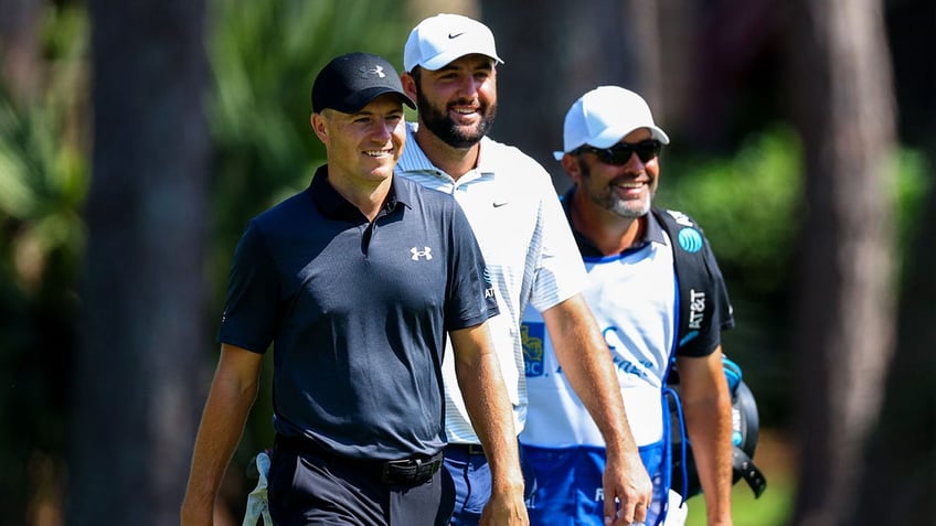 Jordan Spieth and Scottie Scheffler walk on the golf course