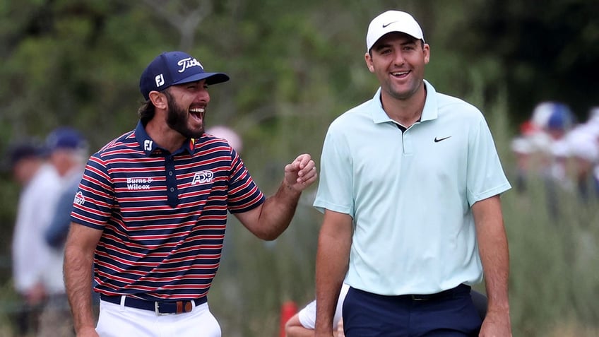 Scottie Scheffler and Max Homa walk on the golf course