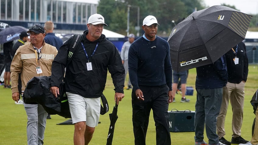 Tiger Woods leaves the driving range