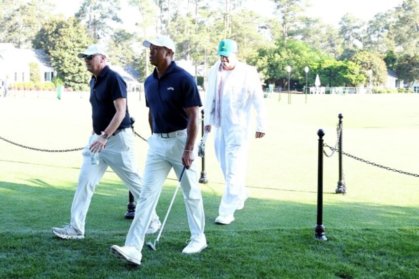 Tiger Woods, center, heads for the Augusta National clubhouse after a Masters practice rou