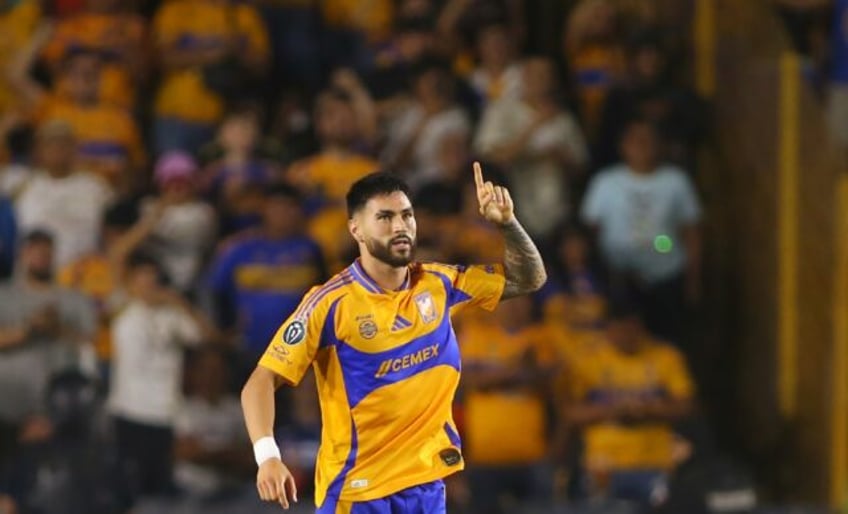 Tigres' defender Juan Jose Purata celebrates after scoring the equalizer against Tigres UA