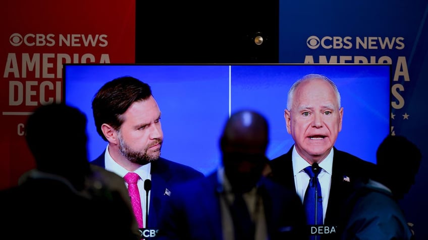 JD Vance and Tim Walz debate shown on TV screen