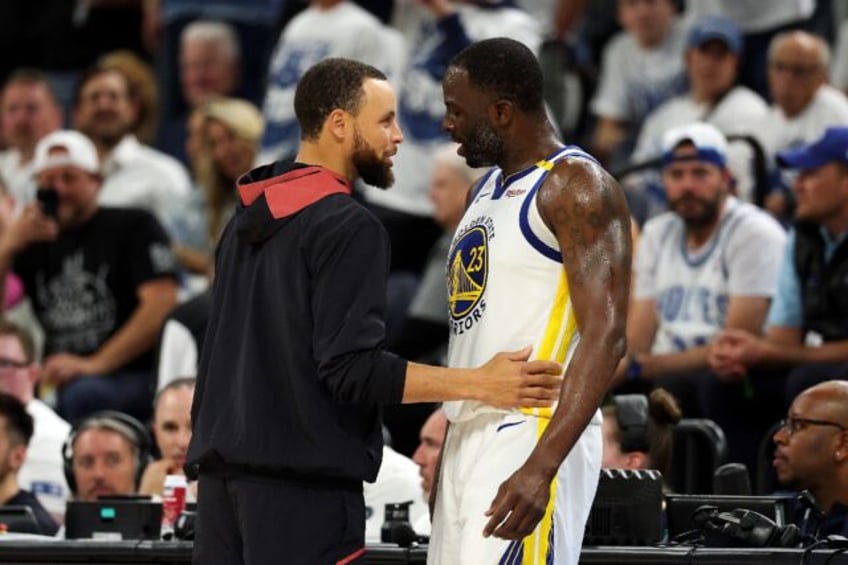 Draymond Green (right) speaks with teammate Stephen Curry after reacting furiously over a