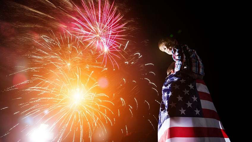 family watches fireworks on the fourth of july