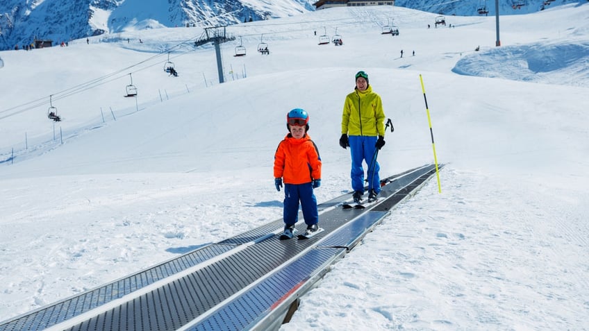 People on carpet ski llift