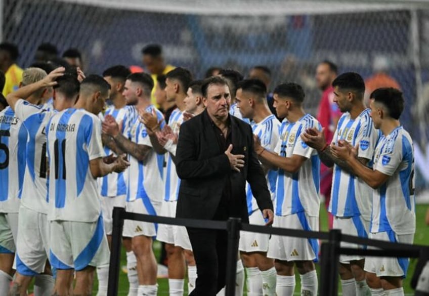 Colombia's Argentine coach Nestor Lorenzo walks past Argentina's players after the Copa Am