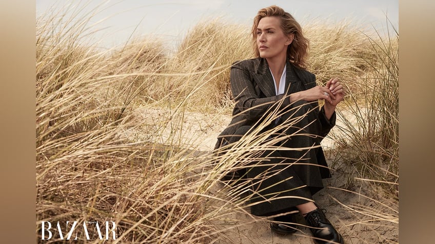 Kate Winslet in a field in a photo for Harper's Bazaar.