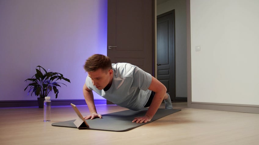 man does push-ups on the floor