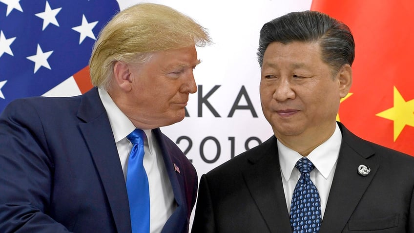 FILE - In this  June 29, 2019, file photo, U.S. President Donald Trump, left, shakes hands with Chinese President Xi Jinping during a meeting on the sidelines of the G-20 summit in Osaka, western Japan.  (AP Photo/Susan Walsh, File)