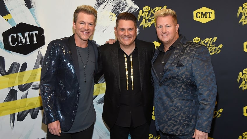 Joe Don Rooney, Jay DeMarcus and Gary LeVox of musical group Rascal Flatts posing together