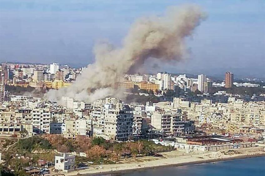 This picture released by Syrian state media shows smoke billowing over the coastal city of