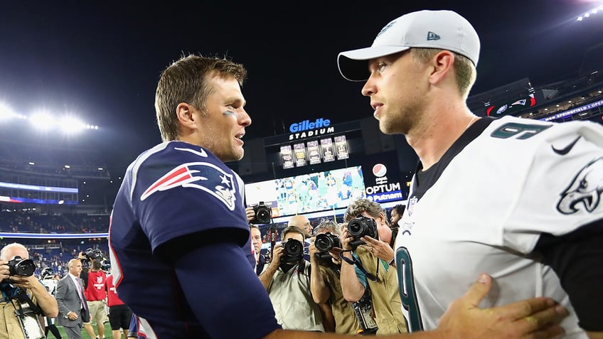 Tom Brady interacts with Nick Foles