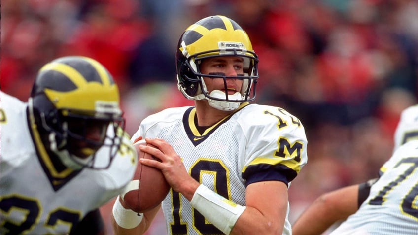 Tom Brady in Michigan uniform drops back