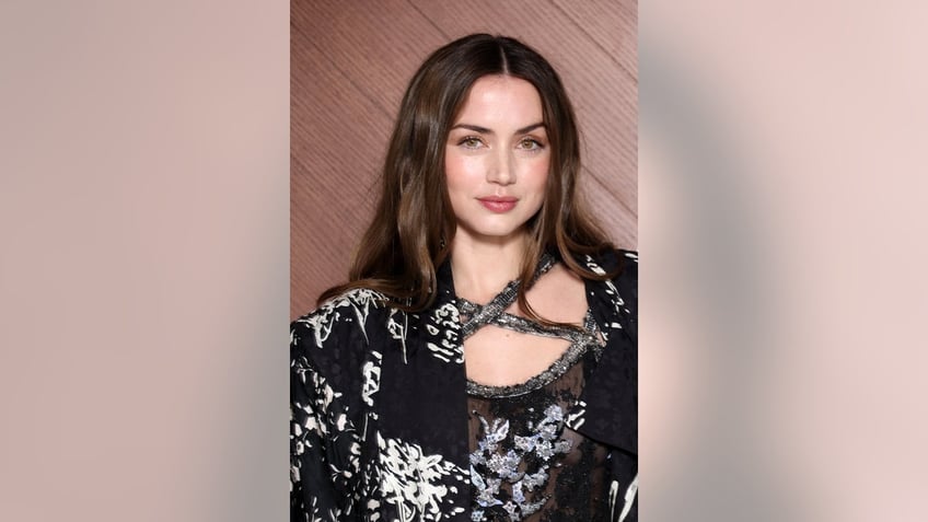 A close-up of Ana de Armas wearing a black and silver dress.