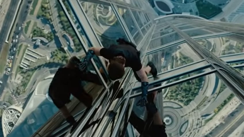 Tom Cruise holds on to glass panels during Mission Impossible stunt