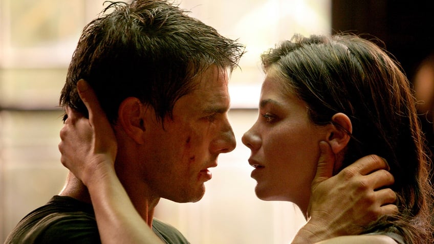 Tom Cruise and Michelle Monaghan look into each others eyes and hold each other in a scene from "Mission: Impossible III"