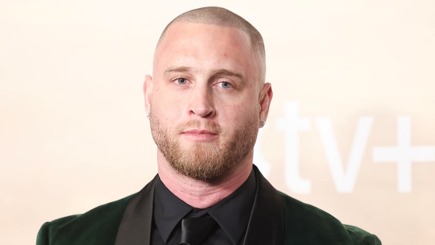 Chet Williams in a dark suit on the carpet