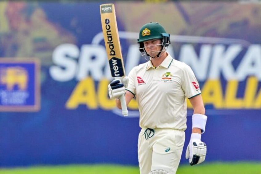 Australia's captain Steve Smith celebrates after scoring his 10,000th run