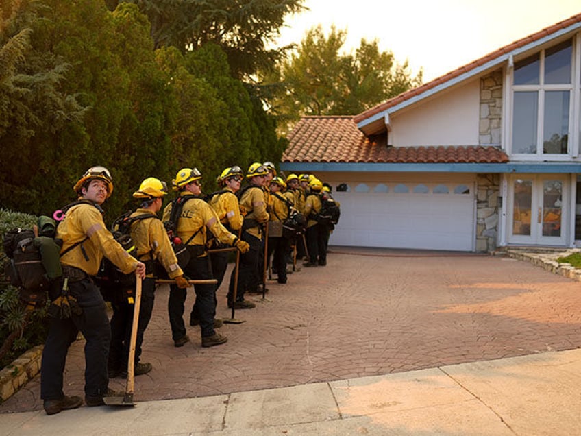 Firefighters line up for structure protection while battling the Palisades Fire in Mandevi