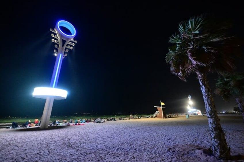 Floodlights illuminate the Umm Suqeim beach in Dubai to make it safer for beachgoers at ni