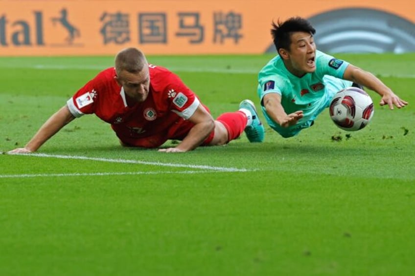 Lebanon defender Robert Melki and China forward Wu Lei battle it out