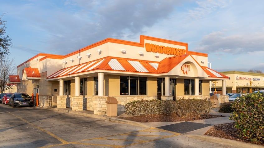 Cars wait in the drive-thru line at a Whataburger in New Orleans.