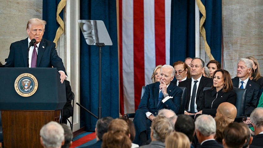 Former President Bill Clinton, from right, former Vice President Kamala Harris, her husband Doug Emhoff and former President Joe Biden listen and President Donald Trump speaks after taking the oath of office