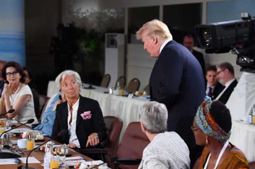 QUEBEC CITY, QC - JUNE 09: Christine Lagarde looks up at US President Donald Trump as he arrives late to the Gender Equality Advisory Council working breakfast on the second day of the G7 Summit on June 9, 2018 in Quebec City, Canada. Canada are hosting the leaders of the …