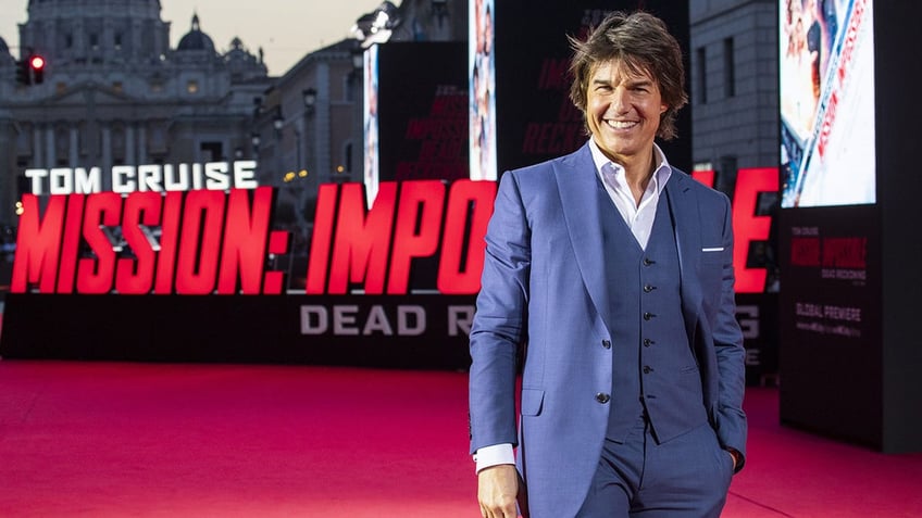 Tom Cruise walks red carpet at Mission Impossible premiere