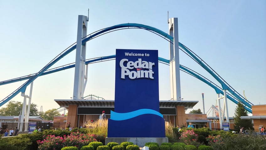 Cedar Point sign with roller coaster in the background.