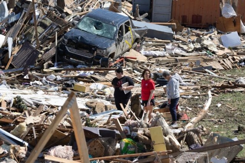 Residents go through the damage after a tornado tore through Greenfield, Iowa