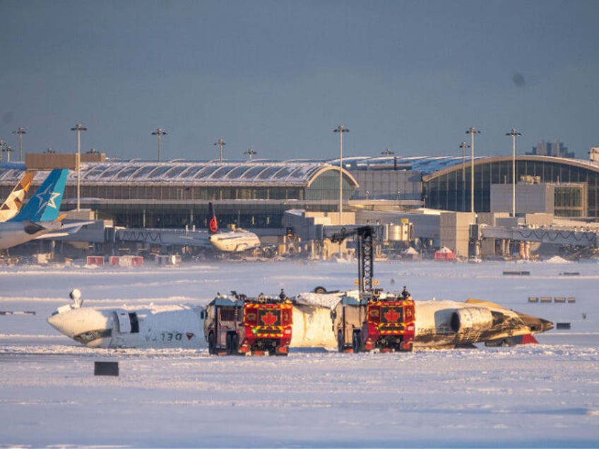 TORONTO, CANADA - FEBRUARY 17: Emergency personnel work at the scene of a Delta Airlines p