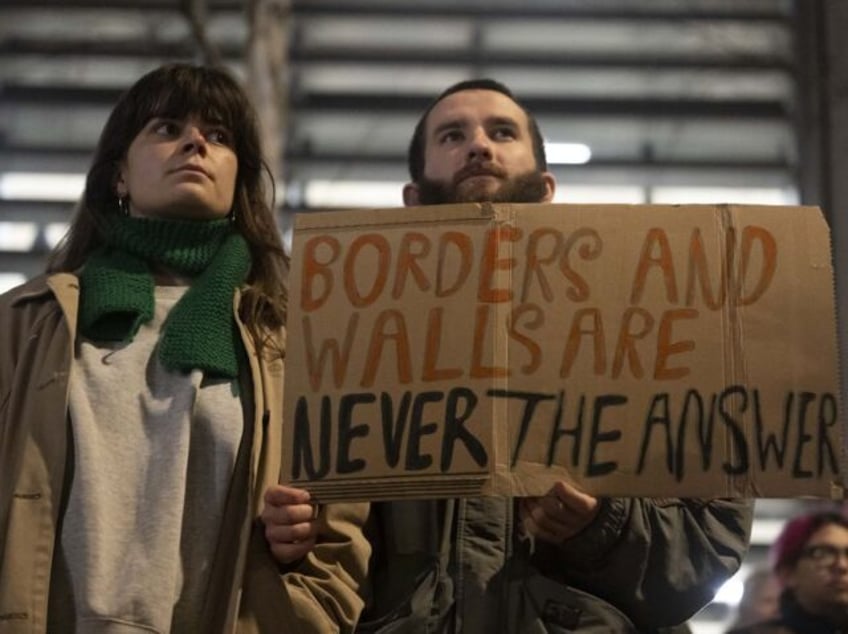 LONDON, UNITED KINGDOM - DECEMBER 18: People gather outside UK Home Office during a demons