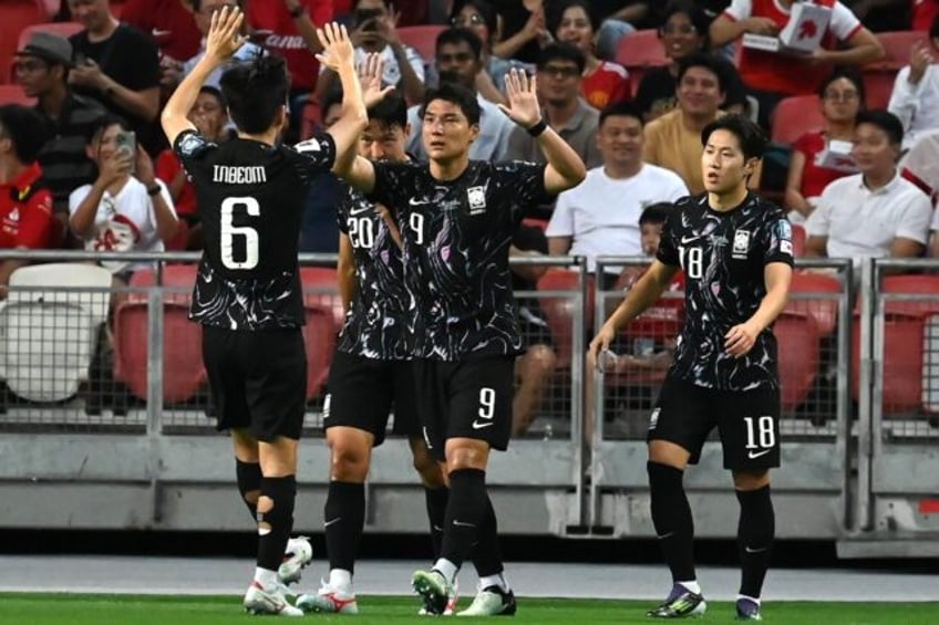 South Korea's Joo Min-kyu (centre) celebrates scoring against Singapore