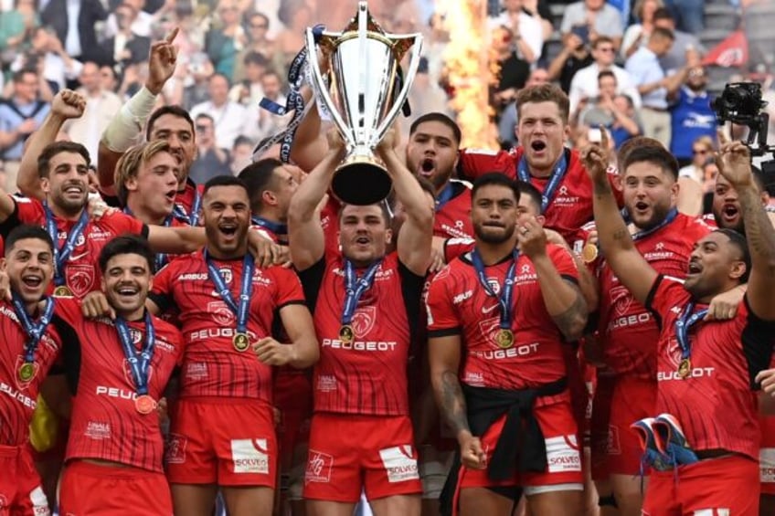 Toulouse's Antoine Dupont lifts the Champions Cup trophy in May