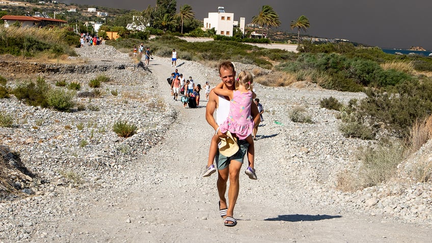 tourists flee vacation destination in just swimsuits as wildfires rage