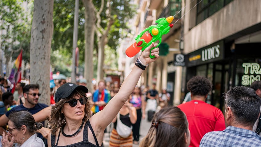 A protester holds a water gun during a protest against overtourism in Barcelona, Spain, Sunday, June 15, 2025. (AA