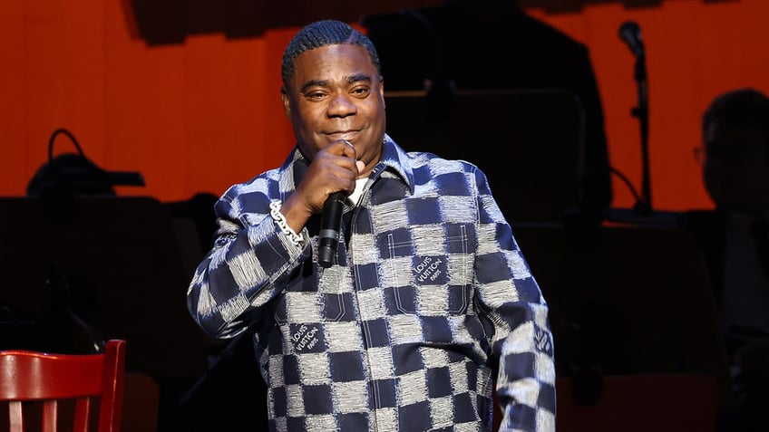 Tracy Morgan on stage holding a microphone