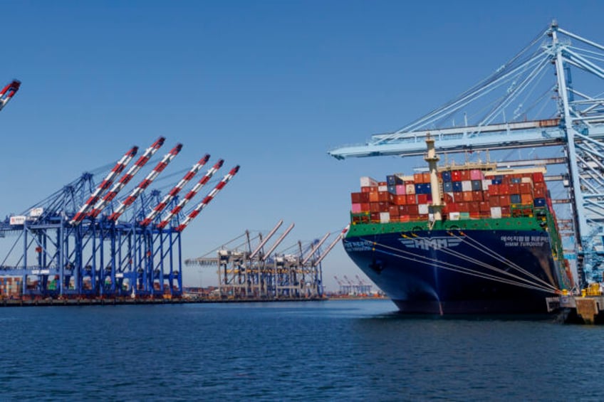 LOS ANGELES, CA - MAY 9, 202: Cargo is loaded onto a container ship on the right while the