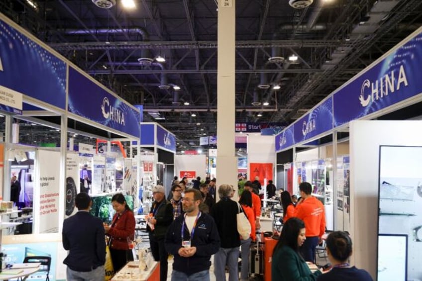 Attendees walk past a row of Chinese businesses at the annual Las Vegas tech show CES in J