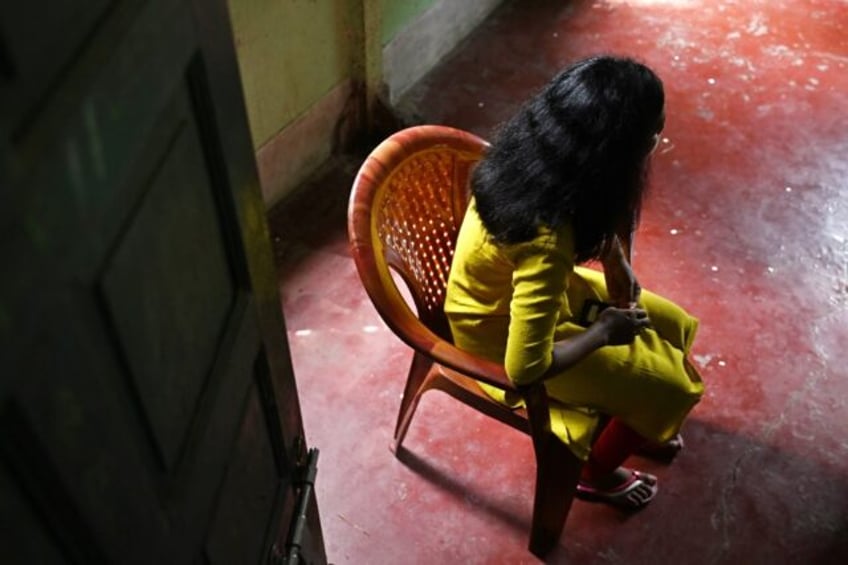 A young Indian woman, rescued from sexual exploitation, speaks with AFP at a house provide