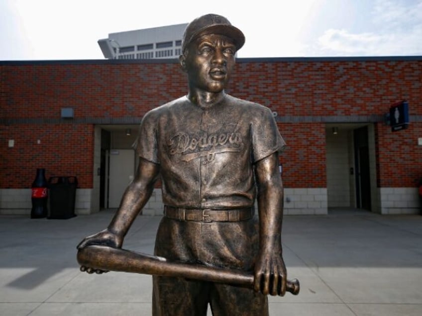 ATLANTA, GA - APRIL 15: A statue of Jackie Robinson stands in the left field stands prior to an MLB game between the Miami Marlins and Atlanta Braves at Truist Park on April 15, 2021 in Atlanta, Georgia. All players are wearing the number 42 in honor of Jackie Robinson …