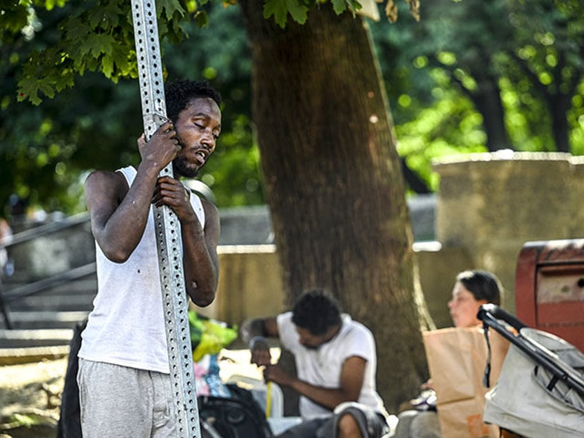 Homeless people are seen on streets of the Kensington neighborhood as homelessness and drug addiction hit Philadelphia in Pennsylvania, United States on July 06, 2023. Many openly inject opioids into their hands, arms and necks. (Photo by Fatih Aktas/Anadolu Agency via Getty Images)