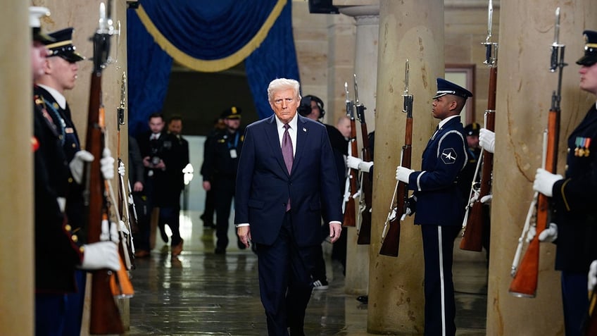 Donald Trump at inauguration flanked by military honor guards