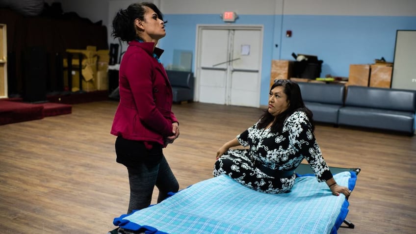 Fabiola Caal Choc, 35, standing left, listens intently to Ruby Corado, sitting right,