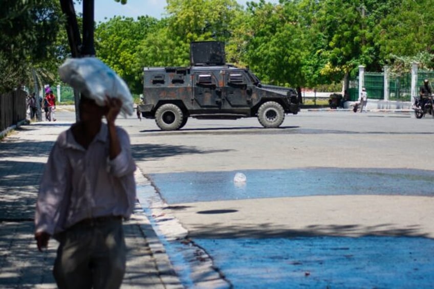 A police vehicle monitors the area near the National Palace in Port-au-Prince, Haiti, on A