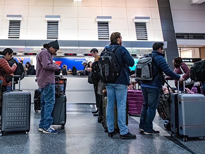 People wait in line to check their luggage at Terminal A at Boston's Logan Airport on Dece