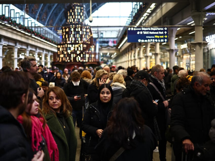 Passengers wait for news of Eurostar departures at St Pancras station in London on December 30, 2023, as services are disrupted due to flooding. Eurostar trains were were cancelled on Saturday due to flooded tunnels, causing misery for people travelling for New Year celebrations in the second major disruption in …