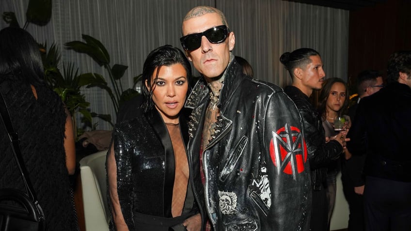 Kourtney Kardashian and Travis Barker pose